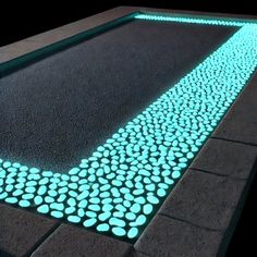 an illuminated walkway in the shape of pebbles