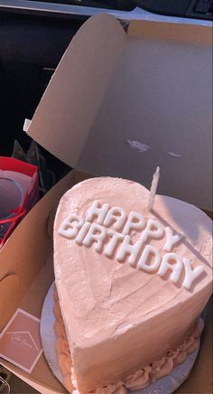 a heart shaped birthday cake with the words happy birthday written on it in white frosting