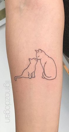 a cat and dog tattoo on the arm