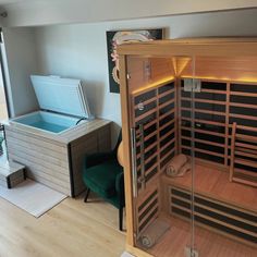 an indoor sauna is shown in the middle of a room with wood flooring