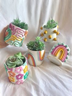 small ceramic pots with plants and rainbow decorations