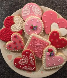 heart shaped cookies are arranged on a plate