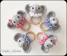 four crocheted elephants with wooden teeth and rings in the shape of an elephant