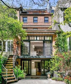 an apartment building with stairs leading up to it