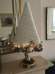 a white christmas tree with lights on it