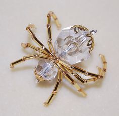 a gold brooch with clear stones on it