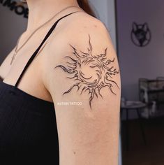 a woman with a sun tattoo on her arm