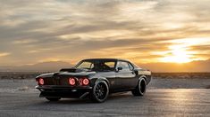 an old muscle car is parked in the desert