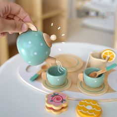 a person pours tea into cups on a table