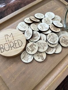 i'm bored wooden coasters on a tray next to a jar of water