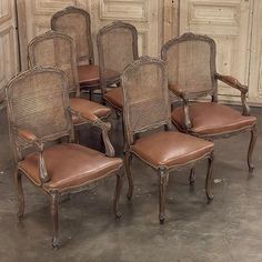 six chairs with brown leather seats in an old room