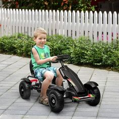 a young boy is sitting on an electric go - kart