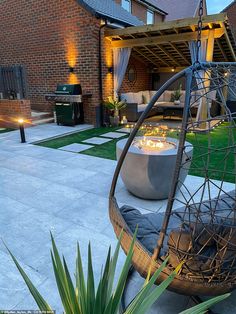 an outdoor living area with furniture and lighting