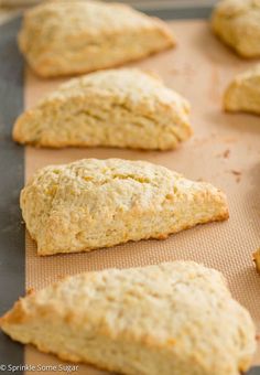 freshly baked scones are lined up on a baking sheet