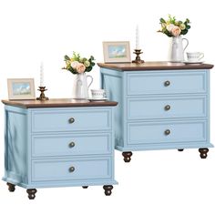 two blue dressers side by side with pictures on top and flowers in vases