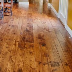 an empty hallway with wooden floors and yellow walls