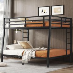 a black bunk bed sitting in a bedroom next to a white rug on top of a wooden floor