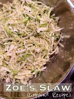 shredded cabbage in a metal bowl with the words zoo's slaw on it