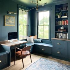 a home office with blue walls and built - in bookshelves