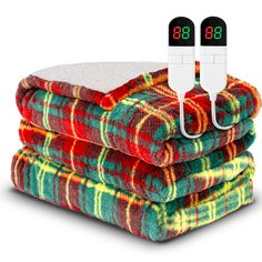 three blankets stacked on top of each other with thermometers attached to them