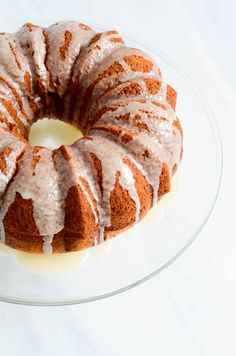 a bundt cake with icing on a glass plate