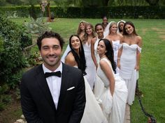 a group of people in formal wear posing for a photo