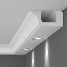 an empty room with three recessed lights on the ceiling