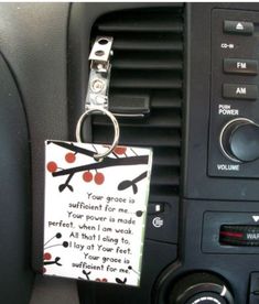 a car keychain with a note attached to it's front dash board