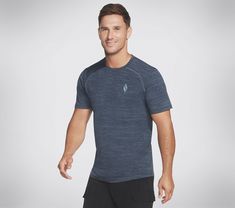 Put some miles behind you in style and comfort with the GO DRI ULTRA FLIGHT On The Road Tee. This short sleeve athletic crewneck tee features a lightweight GO DRI ULTRA FLIGHT breathable jersey fabric made for ultra movement, quick-dry technology, and flatlock seams for ultimate comfort. | Skechers Men's Apparel On the Road T-Shirt | GO DRI ULTRA FLIGHT is a lightweight and breathable performance jersey with active stretch and quick-dry technology to keep you cool and comfortable | Short sleeve T-shirt silhouette | Performance Fit | 100% Polyester jersey | Short sleeve crewneck T-shirt | Contrast cover stitch detail | Flatlock seaming for no-chafe comfort | Skechers diamond logo detail at left chest Ideal Male Body, Mens Skechers, Waterproof Shoes, Skechers Women, Men's Apparel, Grey Fashion, Pants Outfit, Workout Tee, On The Road