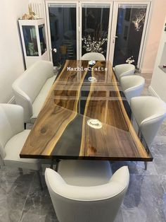 a large wooden table with white chairs around it