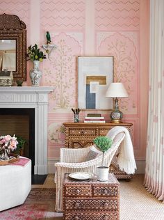 a living room with pink walls and furniture