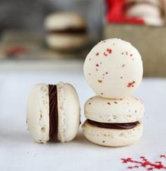 three macaroons are stacked on top of each other and one is half eaten