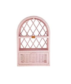 a pink wicker shelf with an arched window on it's sides and a yellow tag hanging from the top