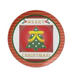 a plate with a christmas tree on the front and merry written in gold, green, and red