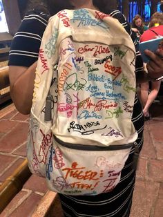 a person wearing a backpack with writing on it