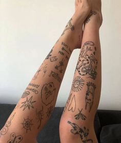 two people with tattoos on their arms and legs