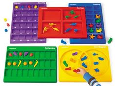 children's hands are playing with plastic trays and toys