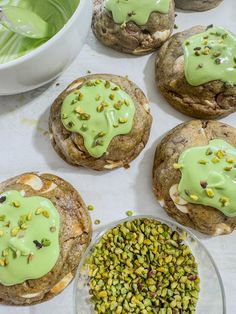 several cookies with green icing on them and some pistachios in the middle