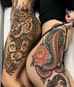 two women with tattoos on their butts, one is showing off her thigh and the other has an arm tattoo