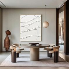 a modern dining room with an abstract painting on the wall