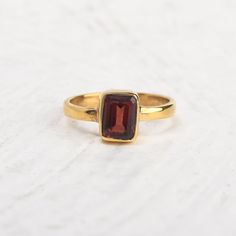 Simple 14k gold vermeil promise ring with single red garnet stone. Tiny stackable everyday ring, January birthstone ring, wedding anniversary ring, gift for the sweetheart. Specifications :--- ✔️ Made to Order ✔️ Metal Options ~ 14K Gold Vermeil  ✔️ Gemstone : Garnet ✔️ Gemstone Size : 6mm x 8mm ✔️ Handmade Jewelry ❤ Everything in my shop is handmade. ❤❤ Each item will be beautifully packed in a recycled box.  I happily take all customized orders. Q: What is 14k gold vermeil? A. Gold vermeil is a type of gold jewelry made to last. The base metal is Sterling Silver which means your piece is made from precious metals only. A thick layer of gold is then electroplated over the base metal. While it may sound similar to gold plated jewelry, gold vermeil jewelry has a much thicker layer of gold. Classic Ruby Stackable Rings As A Gift, Classic Ruby Stackable Rings For Gift, Classic Gold Stackable Ruby Ring, Gold Stackable Ruby Birthstone Ring, Classic Stackable Ruby Ring Gift, Garnet Stackable Rings As A Gift, Stackable Gold Ruby Ring For Gift, Gold Garnet Birthstone Ring Gift, Wine Ring