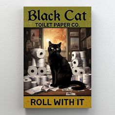 a black cat sitting on top of a pile of toilet paper next to rolls of toilet paper