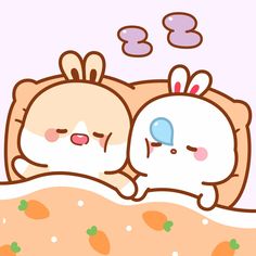 two cute little bunnies laying in bed together