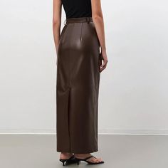 Discover Timeless Elegance and Comfort Embrace the perfect blend of style and comfort with our Vintage Brown Faux Leather Skirt, designed for the modern woman. Crafted with meticulous attention to detail, this ankle-length skirt is a testament to sophistication and versatility, making it an essential addition to your autumn/winter wardrobe. Exceptional Design and Quality Made from a luxurious combination of polyester, spandex, and viscose, this skirt offers a premium leather look without compromising on comfort. The straight silhouette and empire waistline flatter all body types, ensuring a fit that’s both comfortable and stylish. The solid pattern and subtle pocket decoration add a touch of understated elegance, perfect for the office or a night out. Perfect for Any Occasion Whether you'r Elegant Asymmetrical Maxi Skirt For Fall, Chic Fitted Maxi Skirt For Office, Chic Long Pencil Skirt For Fall, Fitted Leather Midi Skirt, Fitted Long Brown Skirt, Elegant Fall Maxi Skirt For Office, Elegant Long Skirt For Fall, High Waist Brown Maxi Skirt For Fall, Chic Brown Maxi Skirt For Fall