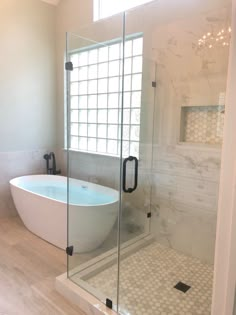 a bath tub sitting next to a window in a bathroom