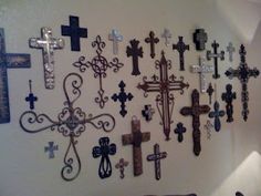 a wall with many different crosses on it