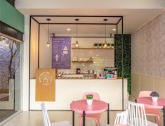 the inside of a restaurant with pink and white tables, chairs, and counter top