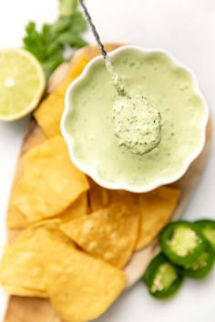 guacamole and tortilla chips on a cutting board