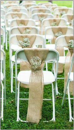 rows of white folding chairs with burlocks tied to them