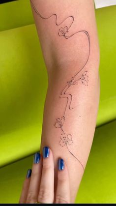 a woman's arm with a lizard tattoo on the left side of her body